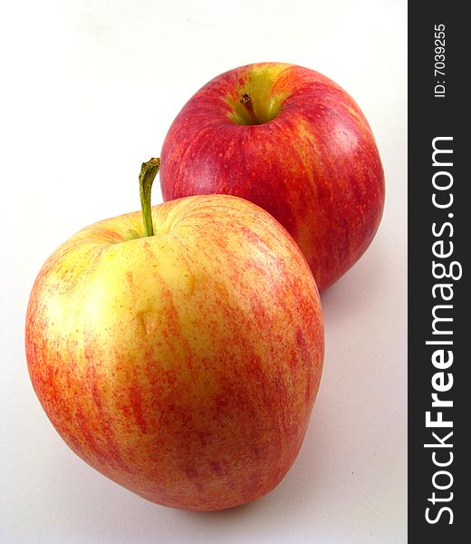 A pair of red apples on a white background. A pair of red apples on a white background