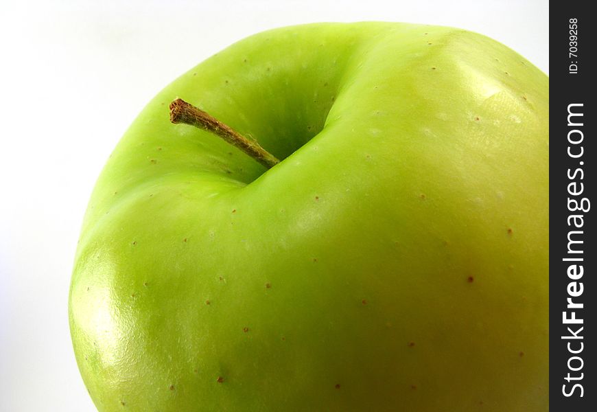 Close-up of a golden delicious apple on white background