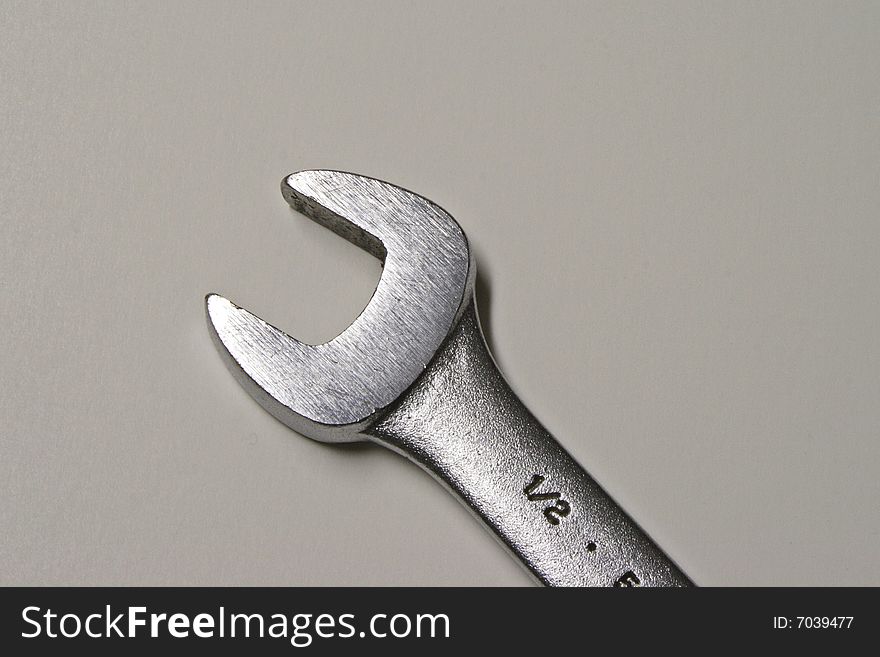 A half inch open end wrench against a gray background