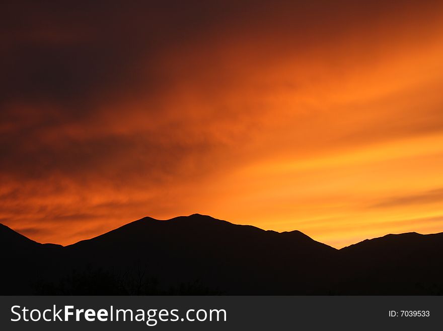 The sun setting behind the Panamint Mountains. The sun setting behind the Panamint Mountains