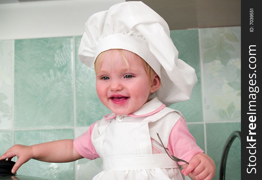 Sitting girl is laughter with fork in hand. Sitting girl is laughter with fork in hand