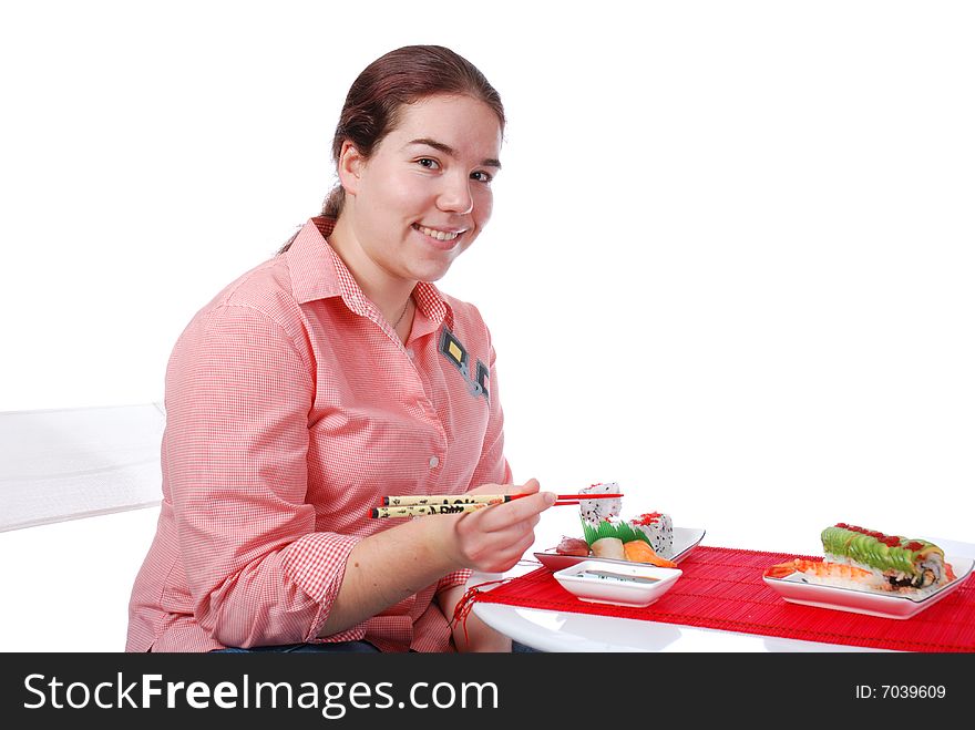 One girl eating rolls and sushi. One girl eating rolls and sushi