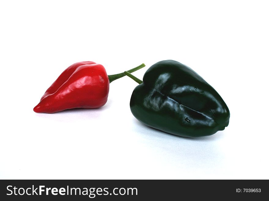 Red and green chiles on a white background