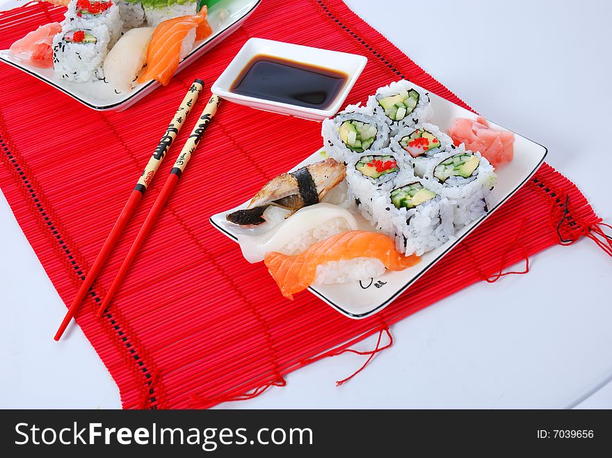 Set of rolls and sushi on several plates. Set of rolls and sushi on several plates