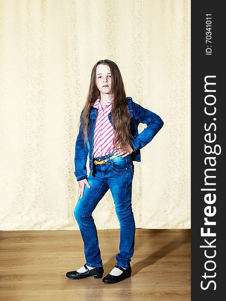 Little Girl With Long Hair In A Blue Denim Suit