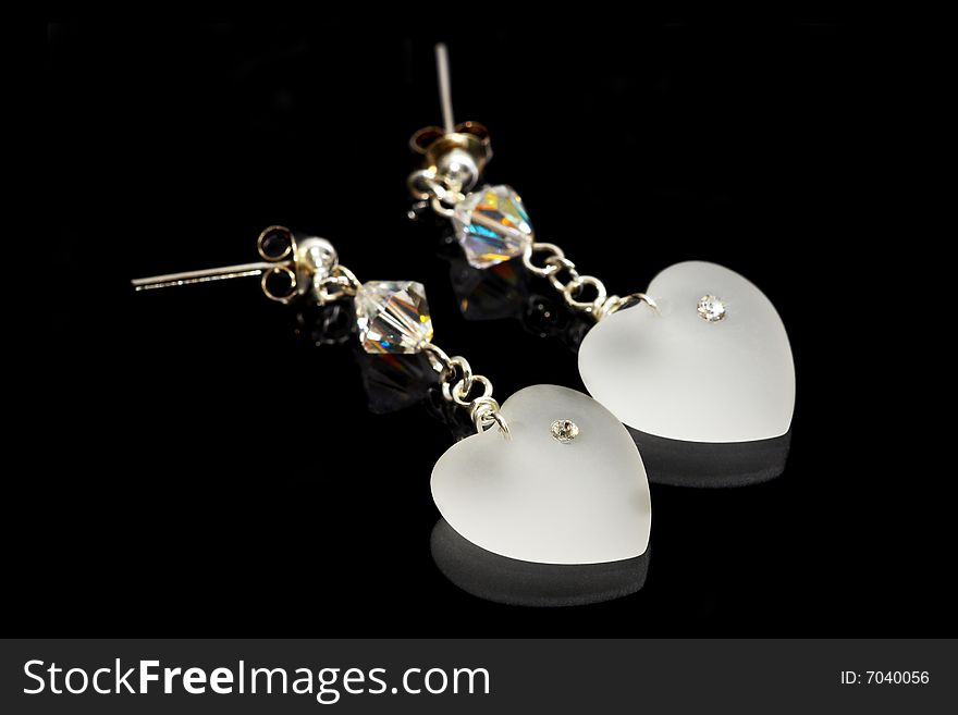 A pair of earrings isolated on black background.