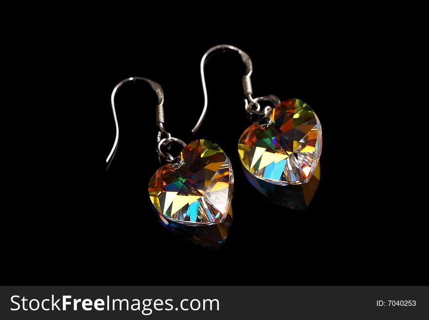 A pair of earrings isolated on black background.