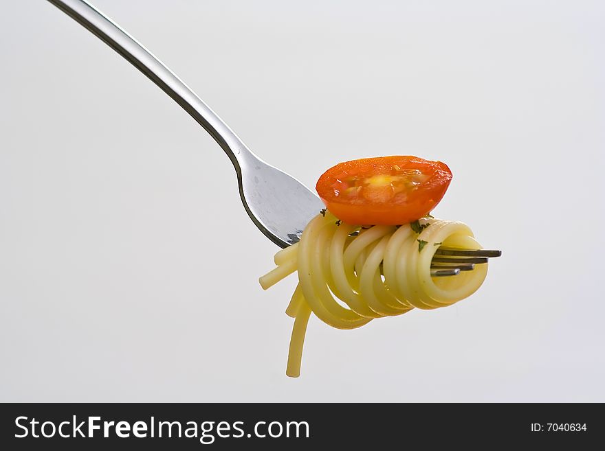 Fork fresh pasta with sauce, tomatoes and oregano