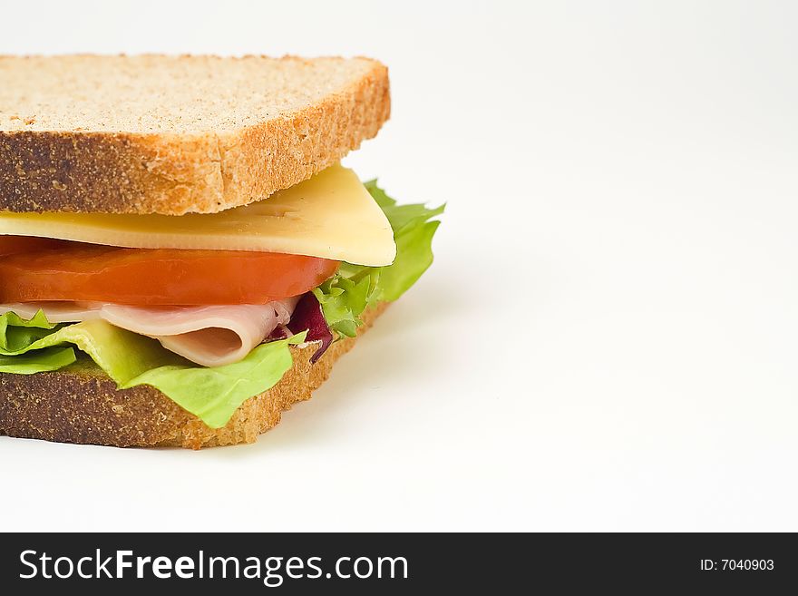 A delicious and healthy sandwich turkey ham cheese lettuce tomato and onion