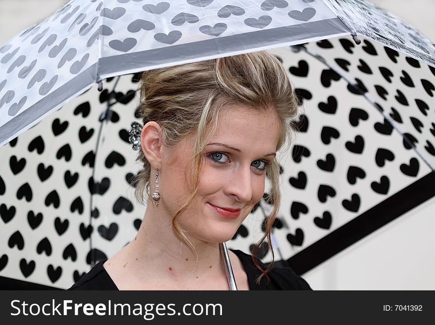 Young smiling woman holding an umbrella. Young smiling woman holding an umbrella.