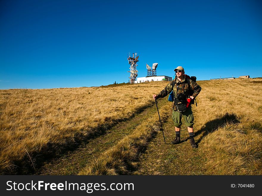 An image of a tourist walking in mountains. An image of a tourist walking in mountains