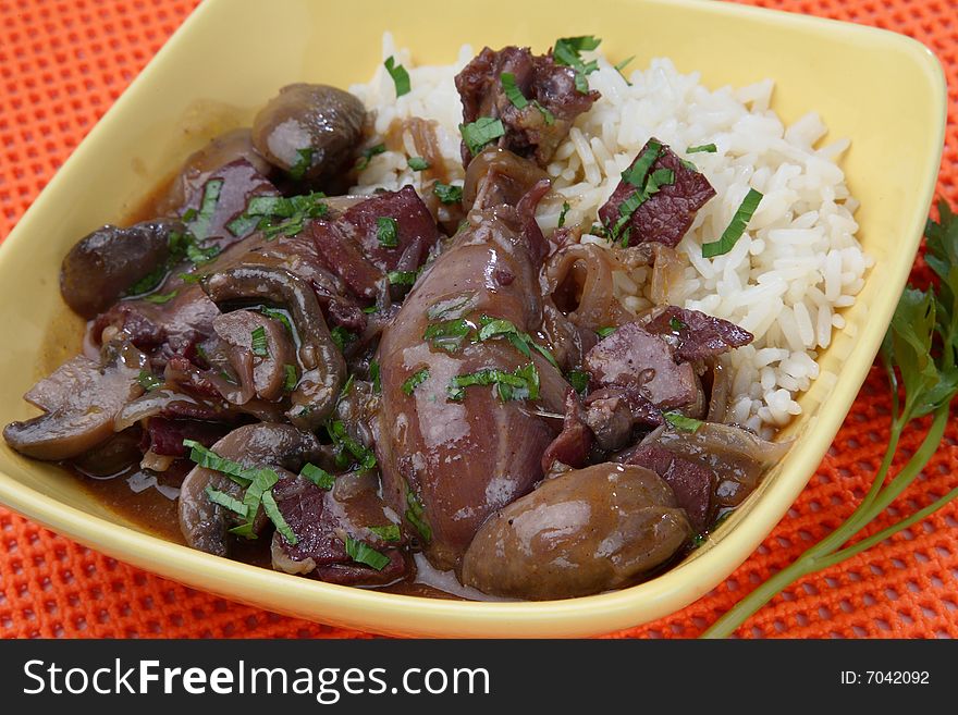 Chicken meat in red wine sauce and boiled rice