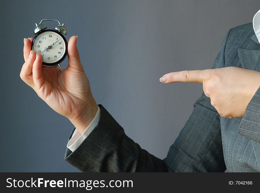 The young businesswoman hold the clock in the hand