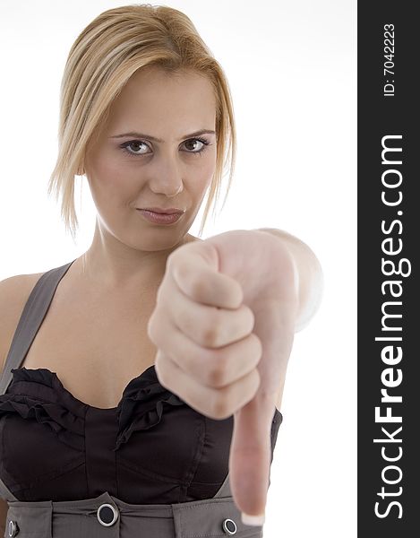 Woman showing thumbs down gesture on an isolated background