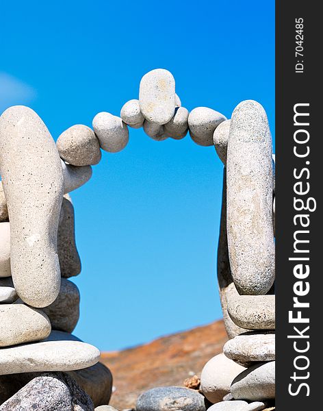 Arch from a sea pebble on a beach in the summer. Arch from a sea pebble on a beach in the summer