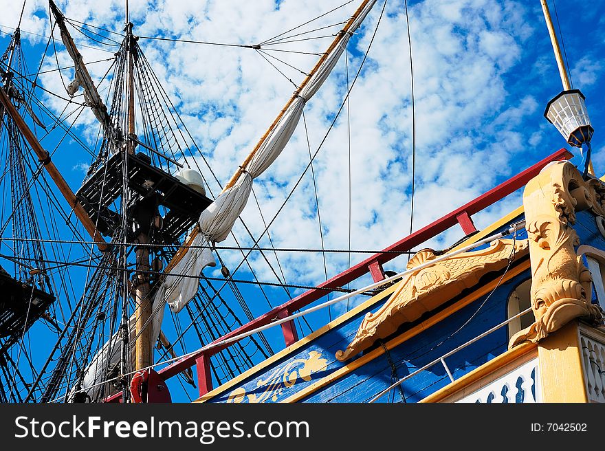 Ancient sailing vessel with the collected sails against the sky. Ancient sailing vessel with the collected sails against the sky