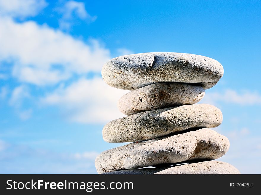 Pile of stones against the sky with clouds