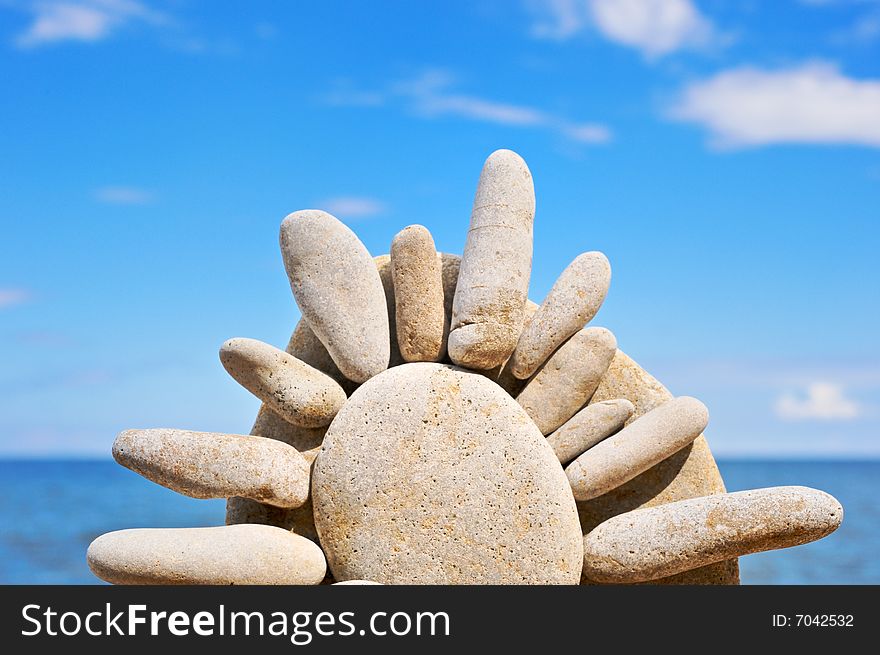 Sea pebble in the form of the sun on a beach in the summer. Sea pebble in the form of the sun on a beach in the summer