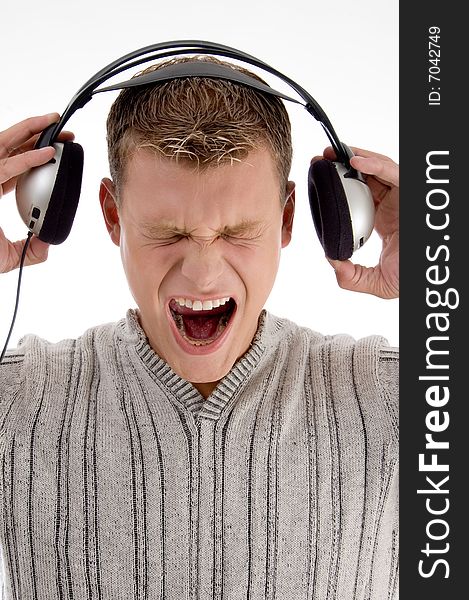 Shouting young man holding the  headphone with white background