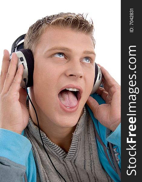 Man listening through headphone against white background