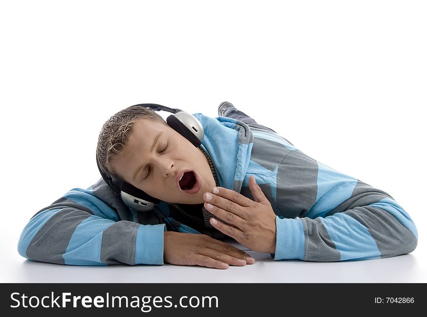 Yawning man with headphone on an isolated white background
