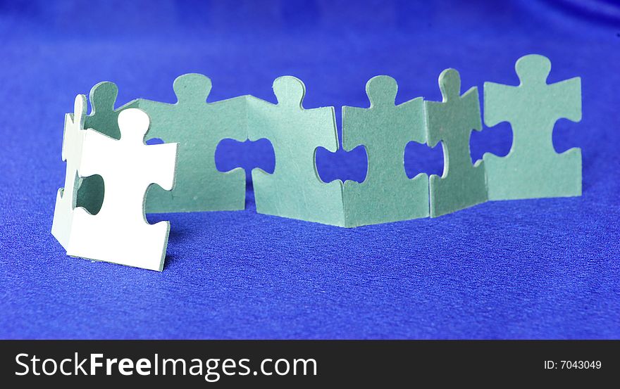 White puzzles isolated on a blue