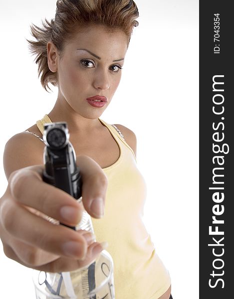 Woman posing with spray bottle against white background