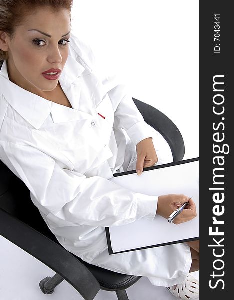 Doctor sitting with writing board against white background. Doctor sitting with writing board against white background