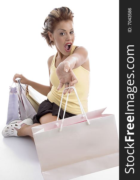 Sitting sexy woman showing shopping bag on an isolated background. Sitting sexy woman showing shopping bag on an isolated background