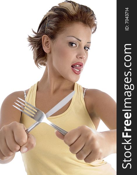 Young woman posing with fork and knife with white background