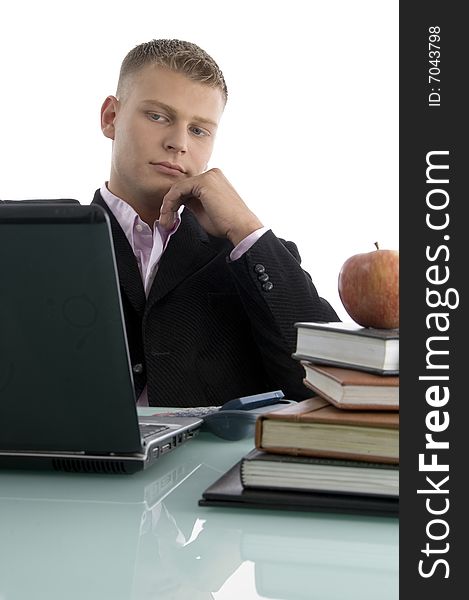 Young businessman looking into laptop with white background