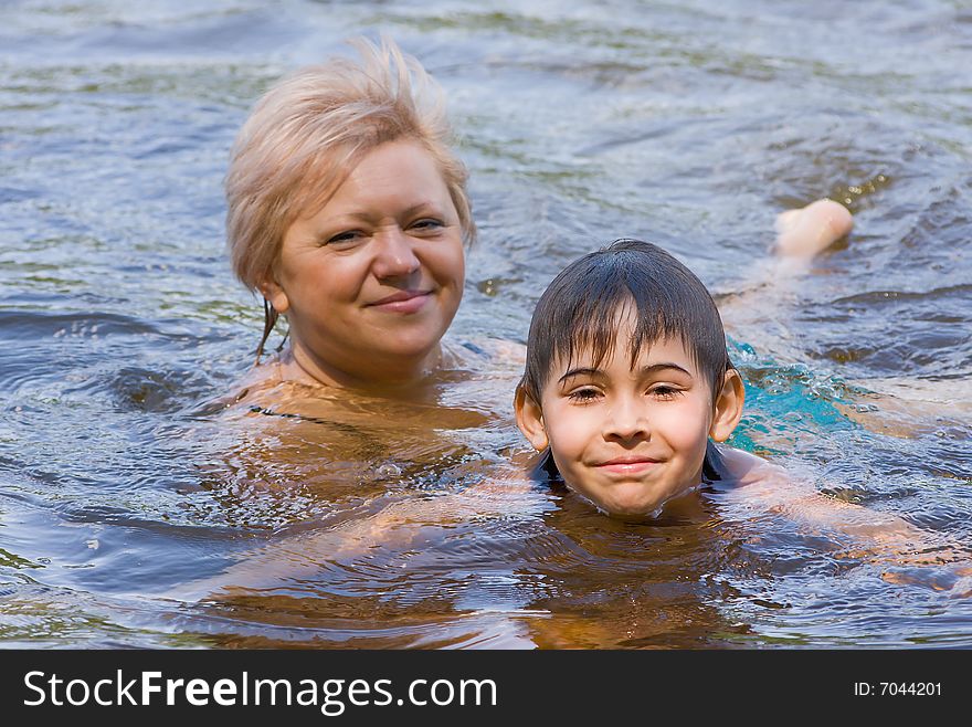 The grandmother and the grandson. Bathing in the river