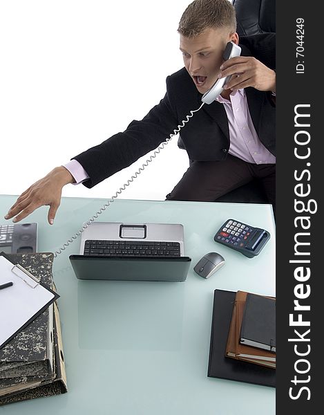 Sitting businessman busy on the phone against white background