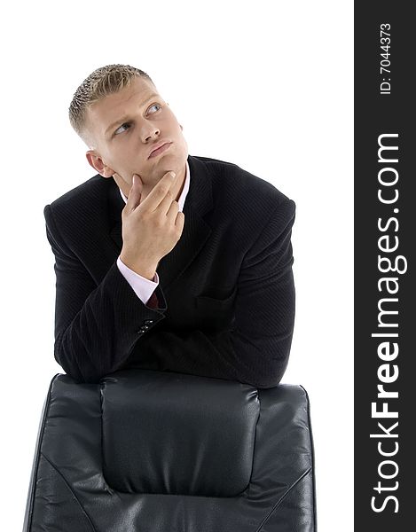 Thinking businessman with chair  against white background