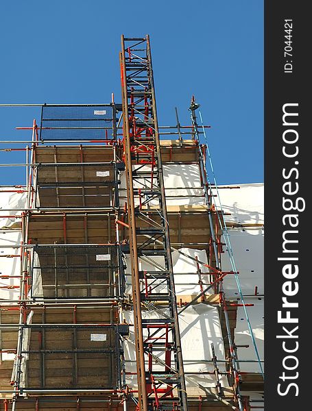 Construction scaffolding covering a building exterior