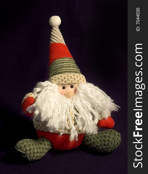 Stuffed Santa puppet against a dark background. Stuffed Santa puppet against a dark background