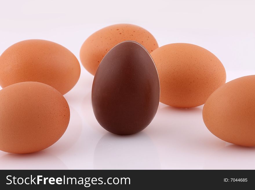 Fresh brown eggs and one Chocolate egg