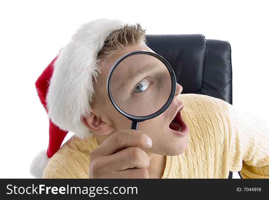 Man wearing santa hat and looking through lens on an isolated background