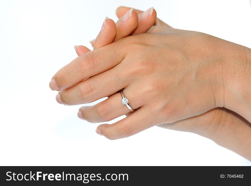 An image of a pair of hands with a diamond ring. An image of a pair of hands with a diamond ring