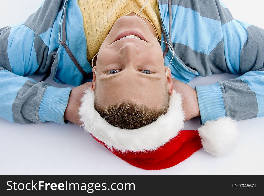 Laying smiling man with christmas hat on an isolated white background