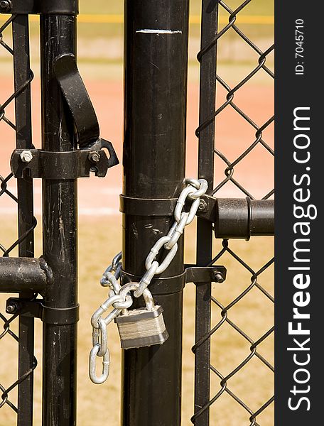 A black chain link fence and an unlocked gate