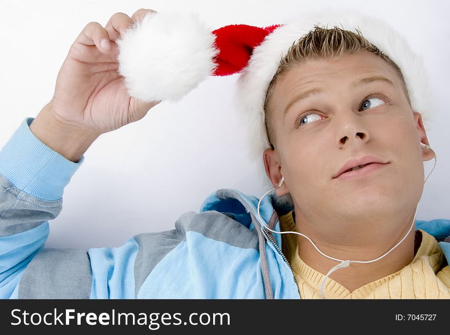 Blonde male looking his christmas hat on an isolated background