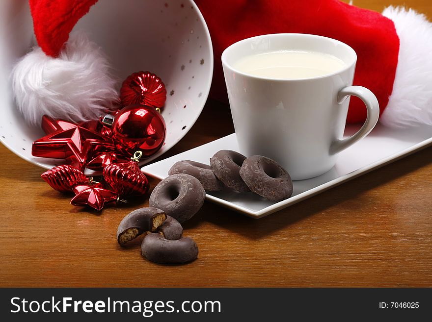 Milk and cookies for santa on table with gold background