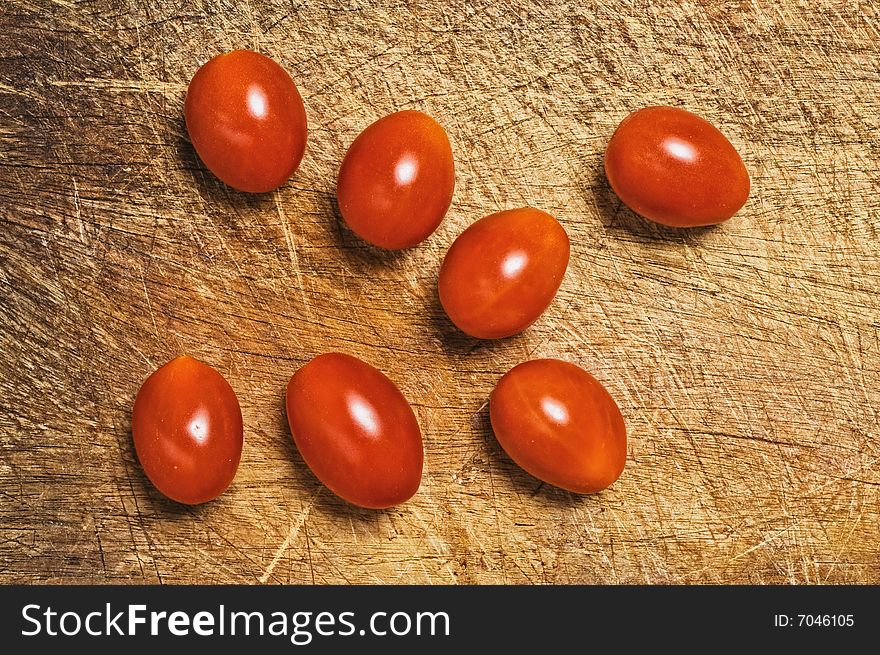 Fresh cherry tomatoes on cutting kitchen board.