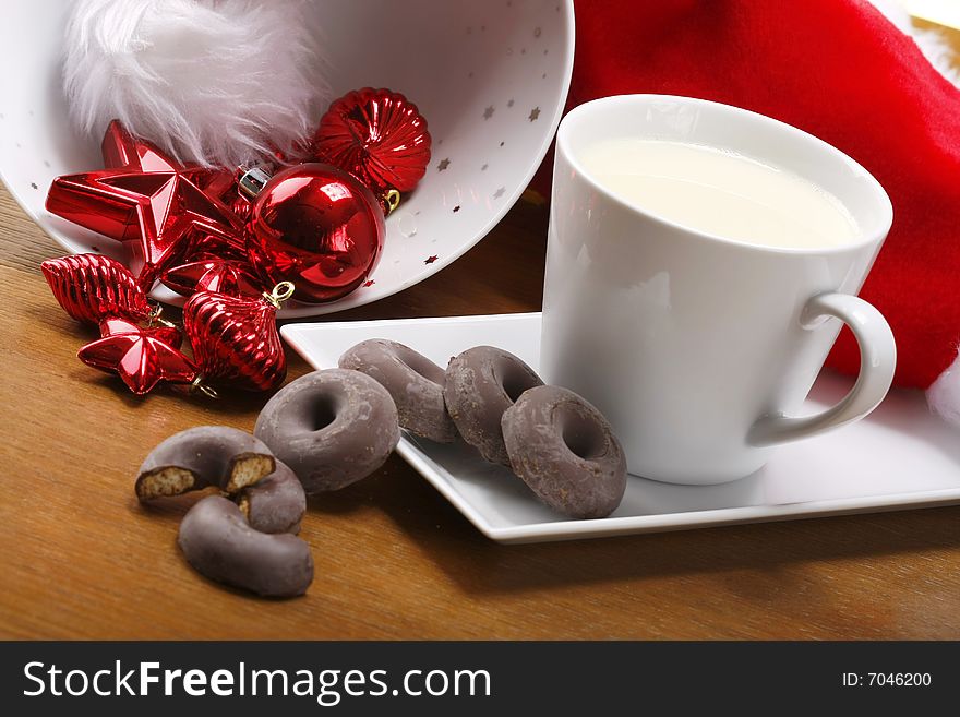 Milk and cookies for santa on table with gold background