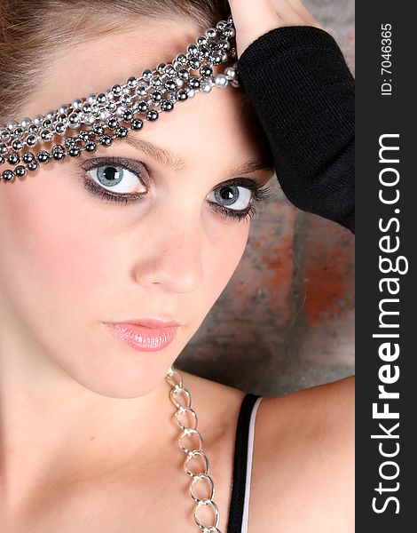 Beautiful model with blue eyes holding strings of beads. Beautiful model with blue eyes holding strings of beads
