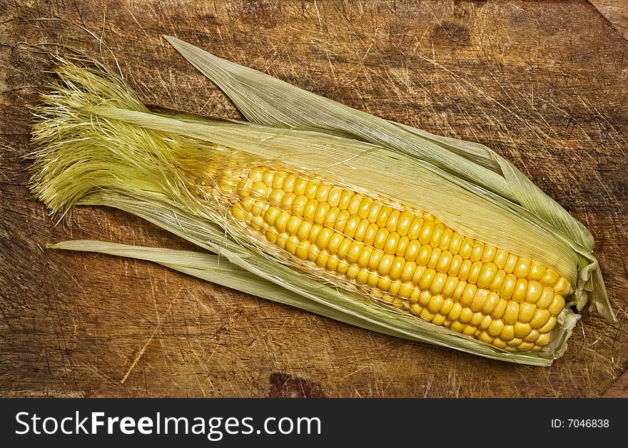 Corn on the cob, isolated on wooden table. Corn on the cob, isolated on wooden table.