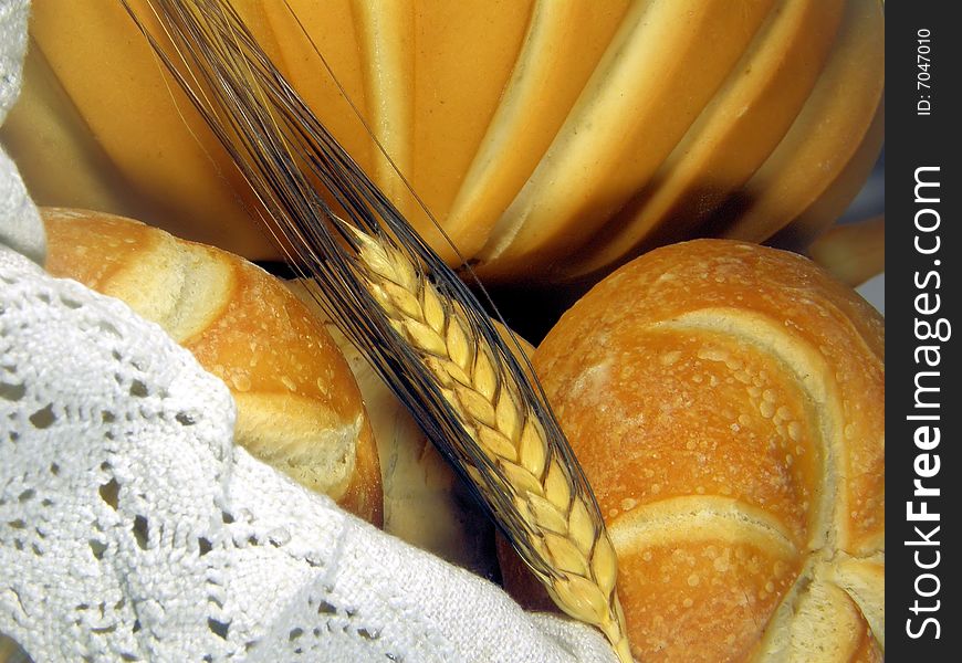 A composition of bread in a basket with an ear. A composition of bread in a basket with an ear