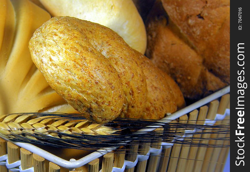 A composition of bread in a basket with an ear. A composition of bread in a basket with an ear