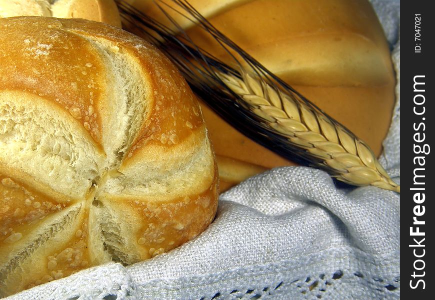 A composition of bread in a basket with an ear. A composition of bread in a basket with an ear